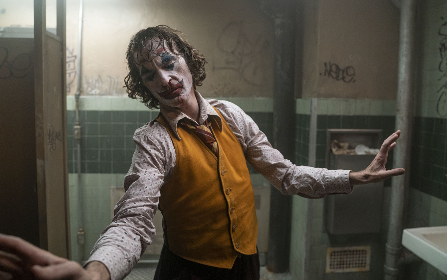 Film still from Joker of Arthur Fleck (Joaquin Phoenix) dancing in bathroom